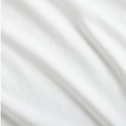 White Washed Linen Sheet Set with soft, casually relaxed fabric folds.