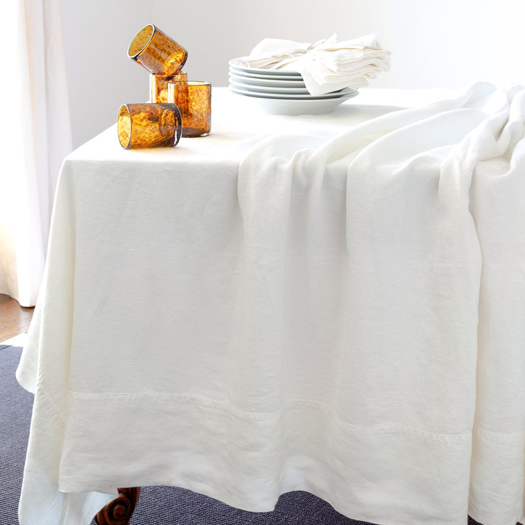 White HG Signature Hand-dyed Linen Tablecloth with generous border and mitered corners.