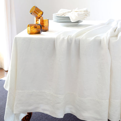 White HG Signature Hand-dyed Linen Tablecloth with generous border and mitered corners.