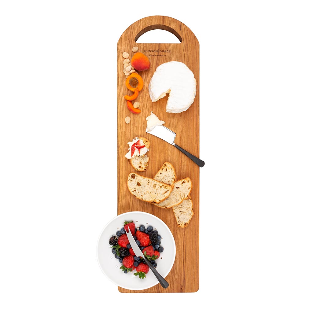 Woodbury Forged Stainless 3-Piece Cheese Knife Set with black handles, displayed on a wooden board.