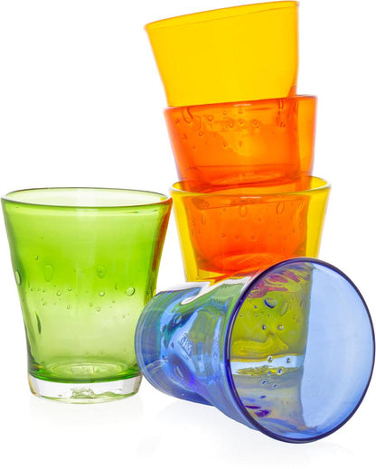 Stack of colorful Henri mouth-blown glass tumblers in yellow, orange, green, and blue with unique air bubbles.